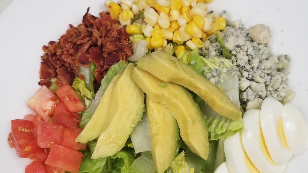 Cobb Salad · Chopped romaine and spinach served with diced tomatoes, crispy bacon, hardboiled egg, avocado, sweet corn, and bleu cheese crumbles. Served with your choice of dressing.