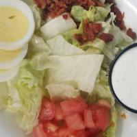 Ob Salad · Romaine lettuce simply garnished with hardboiled egg, diced tomatoes, and crumbled bacon. Se...