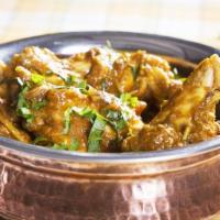 Garlic Chicken Masala · Boneless chicken cooked with onions, ginger, garlic and tomatoes, served with brown sauce.