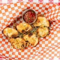 Garlic Knots · A Papa's favorite! Warm, delicious knotted bread slathered in our signature white sauce, top...