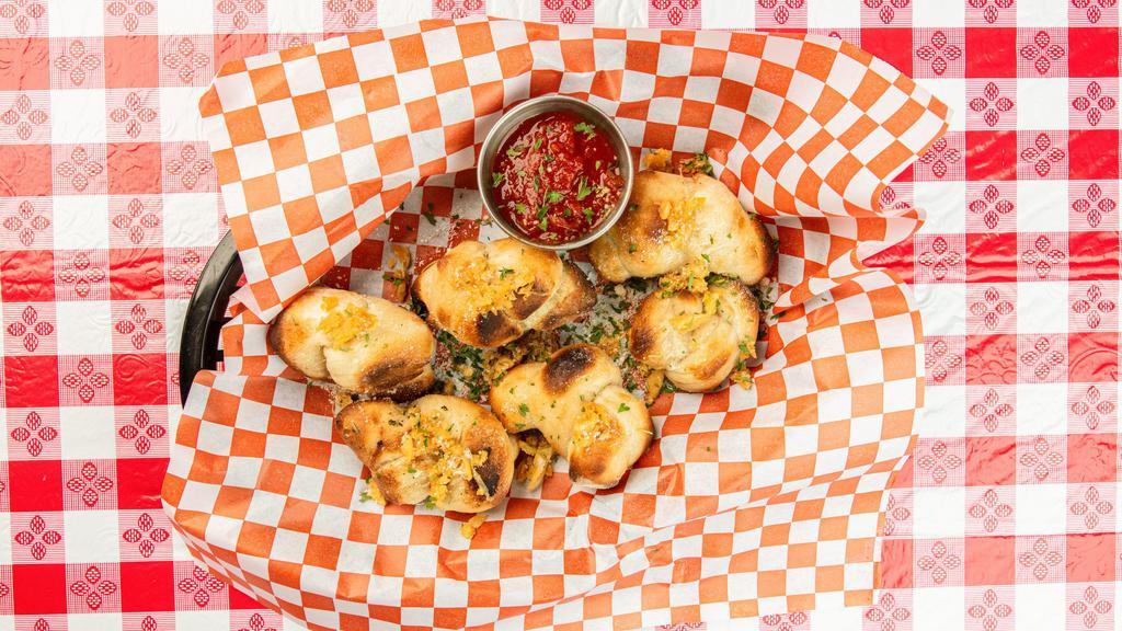 Garlic Knots · A Papa's favorite! Warm, delicious knotted bread slathered in our signature white sauce, topped with fresh roasted garlic and parmesan cheese. Served with a side of Marinara.