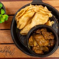 Roti With Goat Curry · Made with flour, cooked on a thin metal plate, and served with curried goat.