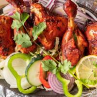 Chicken Tandoori · King of kababs. Spring chicken marinated overnight with yogurt, ginger, garlic and spices.