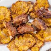 Patacones Con Chicharrón · Fried plantains with pork rinds.