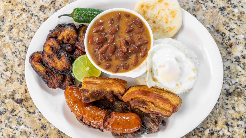 Bandeja Paisa Con Carne Asada · Colombian traditional dish (sirloin steak, rice, beans, pork rind, sausage, avocado, fried egg,  and fried sweet plantains).