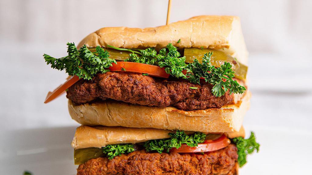 Kotlet Sandwich · Ground beef and potato patty. Served on a hoagie with tomatoes, pickles, and parsley.