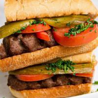 Koobideh Sandwich · Grilled single skewer of ground certified Angus beef. Served on a hoagie with tomatoes, pick...