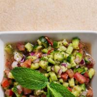 Shirazi Salad · Chopped Persian cucumber, tomato, onion, and mint with red wine vinegar dressing.