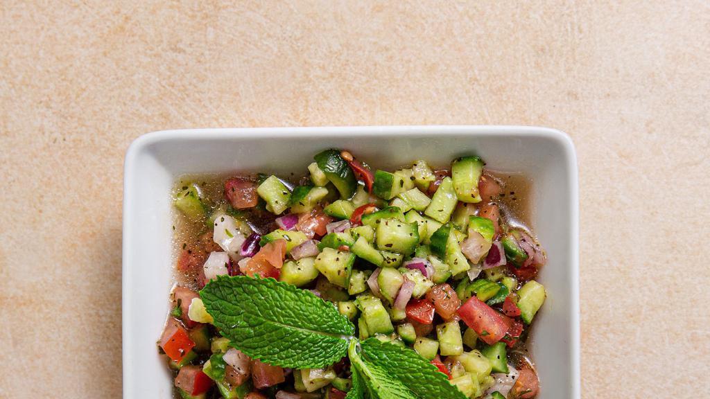 Shirazi Salad · Chopped Persian cucumber, tomato, onion, and mint with red wine vinegar dressing.