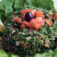 Tabouleh · Parsley, bulgur wheat, tomatoes and onion in an olive oil-lemon juice marinade. Served on ro...