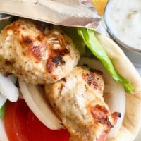 Chicken Souvlaki · Marinated and char-broiled chicken breast. Wrapped in pita bread with lettuce, tomatoes and ...