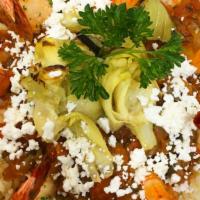 Shrimp Scorpio · Oven roasted prawns, served with artichoke hearts on a bed of rice Pilaf and our fresh tomat...