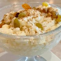 Rizzogalo · Rice pudding. A traditional Greek dessert, flavored with vanilla. Garnished with raisins and...