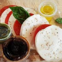 Caprese Salad · Thinly sliced heirloom tomatoes, fresh mozzarella, pesto, balsamic glaze, extra virgin olive...