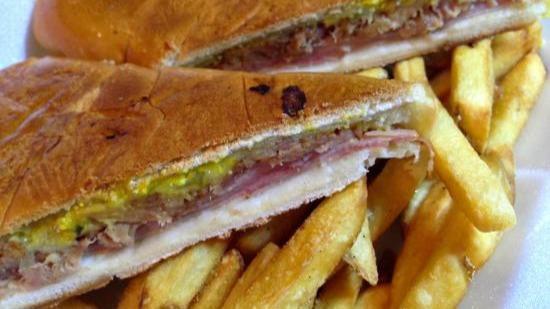 Cuban Sandwich · Slow roasted pork, ham, pickles, melted swiss cheese, mustard, and mayonnaise on a fresh roll. Served with french fries.