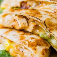 Quesadilla · Flour tortilla filled with melted cheese, zucchini, salad, and sour cream.