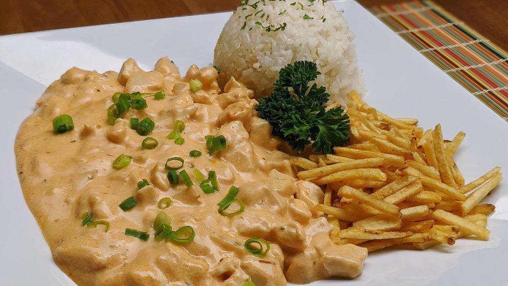 Mama'S Stroganoff (Stroganoff Da Mama) · Creamy sauce with your choice of meat and spices on top of fresh cooked rice. This is a traditional comfort food dish in Brazil! 
Served with rice and shoestring potatoes chips.