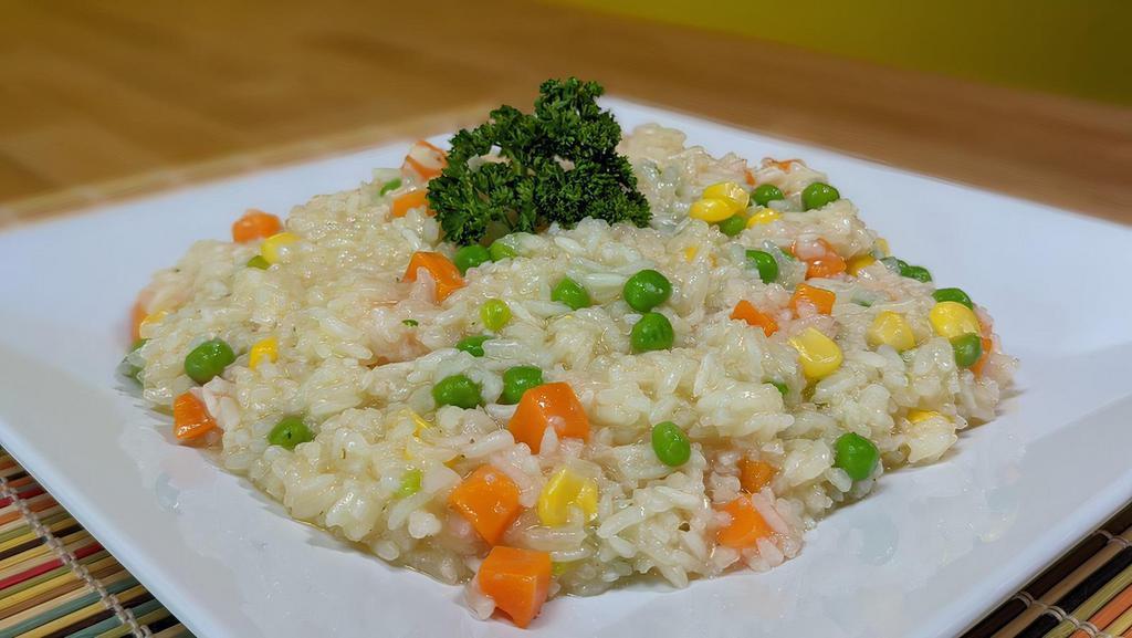 Mama'S Risotto · Light and flavorful Brazilian style risotto is not the traditional buttery risotto, much lighter and healthier but yet still a little creamy. Made with carrots, peas and sweet corn. Served with your choice of protein.