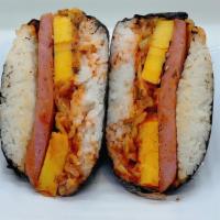 Kimchi Musubi · Supersize Musubi (spam, kimchi, eggs. gojuchang sauce, toasted sesame seeds) wrapped in roas...