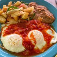 Huevos Rancheros · Two eggs (any style), topped with salsa ranchera; served with papas con chile, refried beans...
