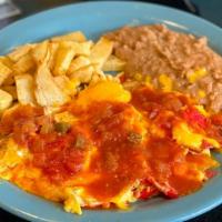 Chilaquiles Con Huevo · Corn tortilla chips mixed with eggs, topped with melted cheese and salsa ranchera; served wi...