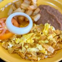 Migas Con Huevo · Corn tortilla mixed with eggs, served with potatoes and refried beans.