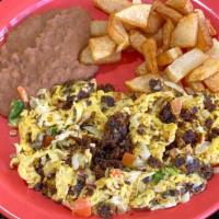 Machacado Con Huevo · Carne Seca dry beef, mixed with eggs, tomatoes and onions; served with beans and potatoes.
