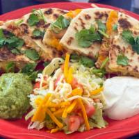 Quesadillas (Cheese) · Toasted or deep fried flour tortillas stuffed with Monterey jack cheese, served with guacamo...