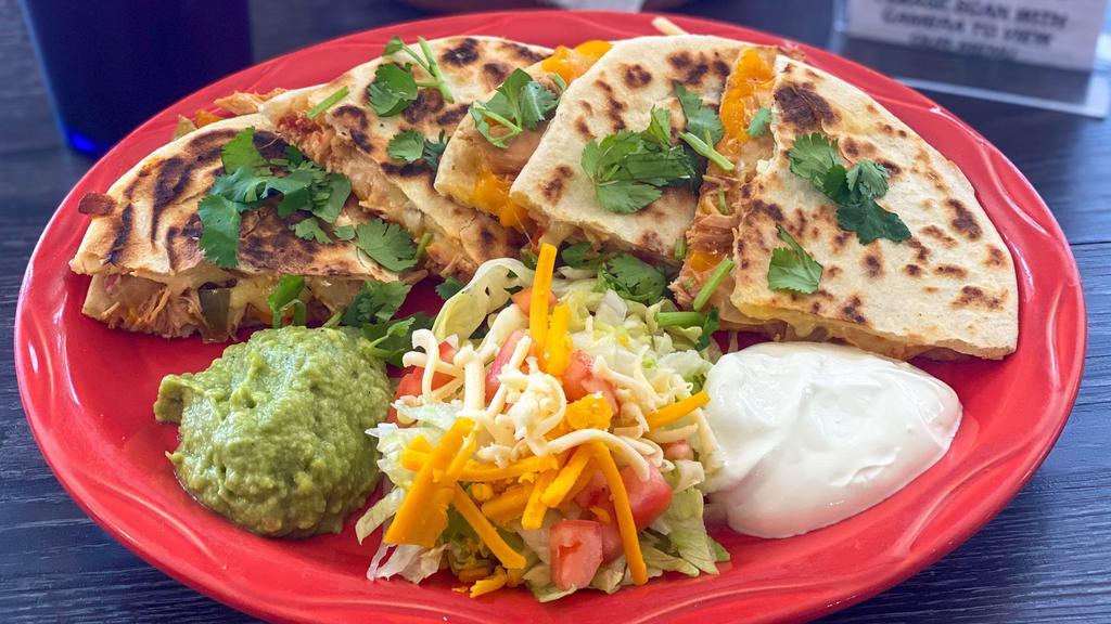 Quesadillas (Cheese) · Toasted or deep fried flour tortillas stuffed with Monterey jack cheese, served with guacamole and sour cream.