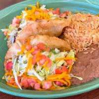 Puffy Taco Plate · Two pieces tacos filled with your choice of picadillo or pollo guisado; topped with lettuce,...
