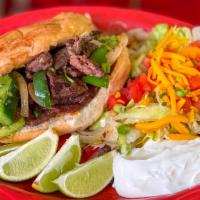 Torta Loca · French bread filled with beef, chicken or pork fajitas, topped with guacamole, lettuce, toma...