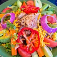 Chef Salad · Taco salad bowl filled with lettuce, tomatoes, carrots and celery, topped with avocado slice...