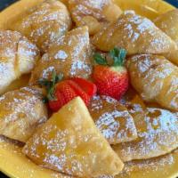 Sopapillas · Deep fried flour dough puffed and sprinkled with cinnamon and sugar, served with strawberrie...