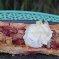 Crostata · Crispy puffed pastry filled with seasonal fruits, topped with sweetened cream, citrus peel, ...