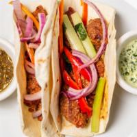 Lamb Tacos · Organic leg of lamb cubes, marinated with our special blend of spices served with House Slaw...