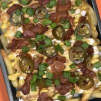 The Big Load · loaded cheese fries topped with sour cream, dank sauce, bacon, jalapeño and green onion