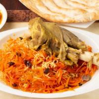 Lamb Shank (Spacil Afghan Dish) · A big shank of tender lamb under the rice with carrot and risan served with fresh afghan bre...