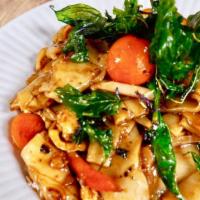 Drunken Noodle · Spicy. “Pad kee-mao”, wide rice noodle, bell pepper, onion, tomato, and basil, in chili garl...