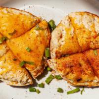 Crabby Cheesy Pretzel · Creamy crab dip baked open face on pretzel bread halves with Jack and Cheddar cheeses, garni...