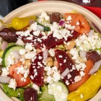 Greek Salad · Romaine lettuce, feta, tomato, red onion, beets, cucumber, olives, garbanzo beans.