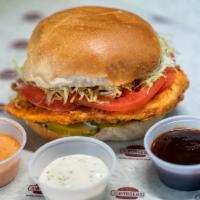 Crispy Original Chicken Burger · Lightly fried chicken breast, lettuce, tomato, pickles, and mayonnaise on a fresh baked deli...