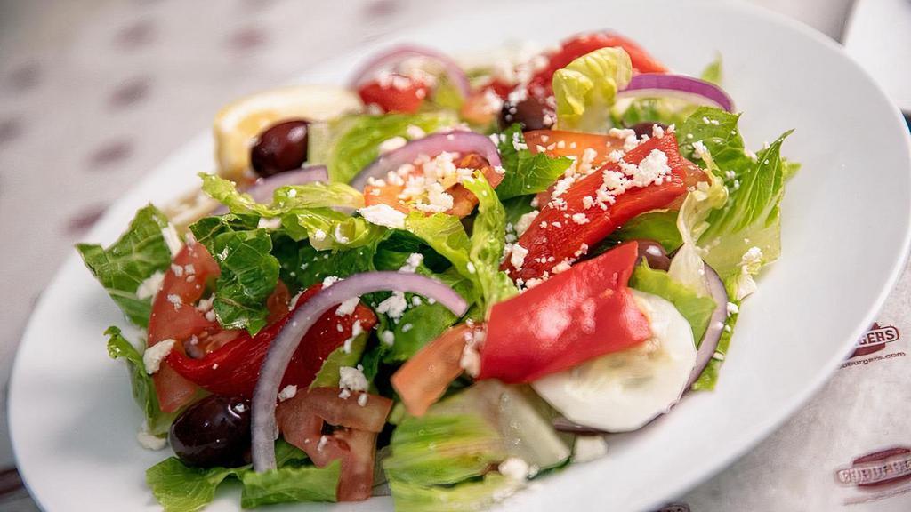 Signature Greek Salad · Romaine lettuce, vine ripened tomatoes, feta cheese, sliced cucumbers, red onions, Kalamata olives, peppers, and our signature Greek dressing.