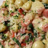 House Gnocchi · Potato dumpling pasta sautéed with fresh spinach, Italian ham and roasted red peppers in our...