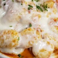 Penny'S Gnocchi · Potato gnocchi simmered in our spicy vodka sauce, topped with mozzarella and baked en casser...