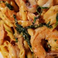 Penne La Rosa · Shrimp sautéed with fresh mushrooms and spinach in our creamy sun-dried tomato garlic pesto ...