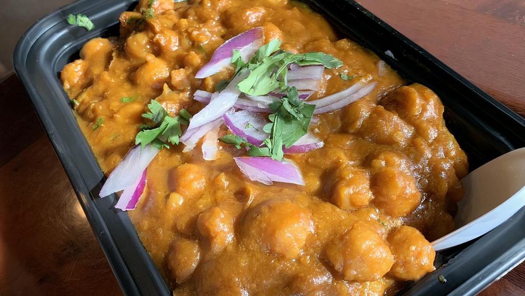 Chana Masala (Chole) · Vegan, gluten free, vegetarian. Chickpeas cooked punjabi-style with fresh tomato, onion, ginger, spices, and herbs. Includes rice.