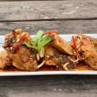 Thai Boxing Chicken Wings · Crispy thai-style fried chicken wings (5 pieces) tossed in either: spicy tamarind sauce (wet...
