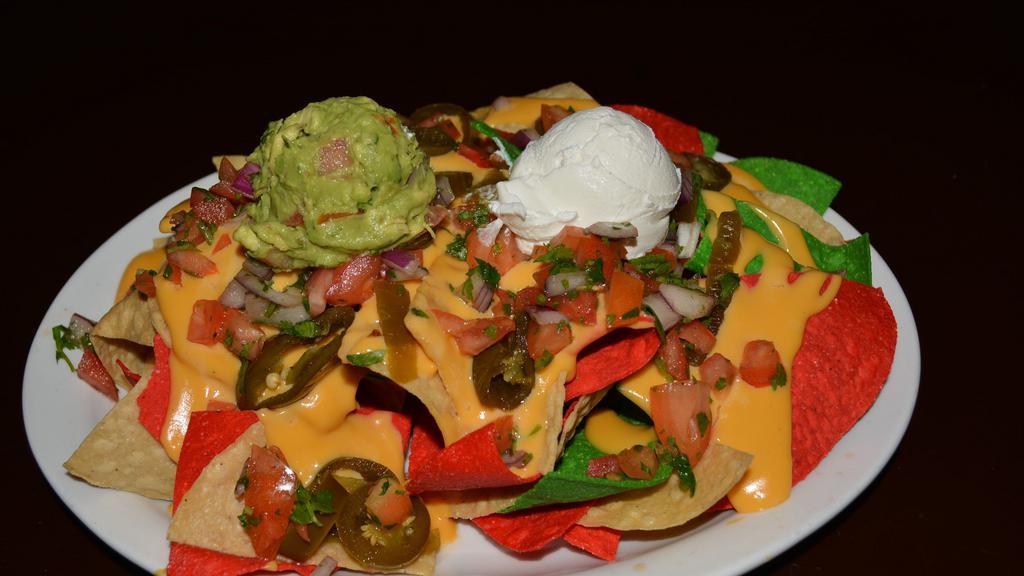 Loaded Nachos · Guacamole, Pico De gallo, sour cream melted cheese, Jalapeños served on three colors of tortilla chips. Also you have the option to choose Grilled chicken, chili beef or Smoked pulled pork with an extra charge.