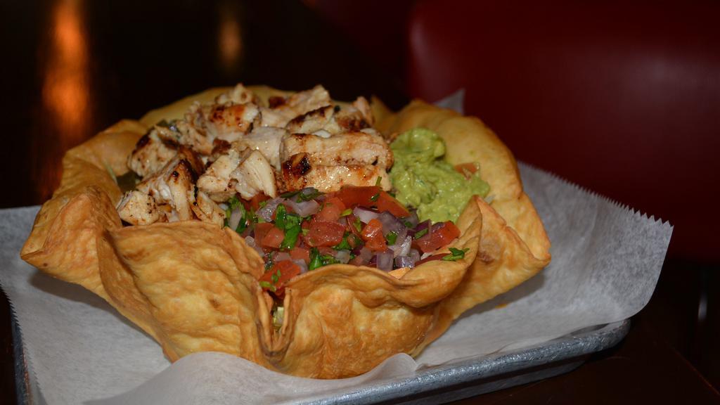 Taco Salad · Guacamole, pico de gallo, sour cream, shredded cheese mix, jalapeños, salsa and grilled chicken. served on shredded romaine lettuce. Add chicken, avocado, or grilled shrimps for an additional charge.