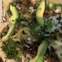 Ivan'S Tacos · Three tacos with chorizo, steak and chicken with onions, jalapenos and cilantro. Served with...